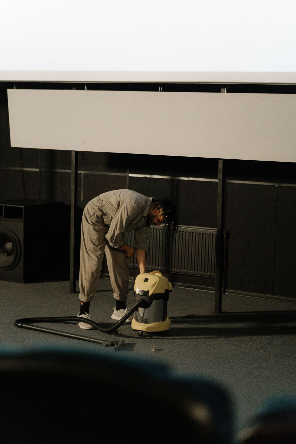 Technician vacuuming a large commercial carpeted floor