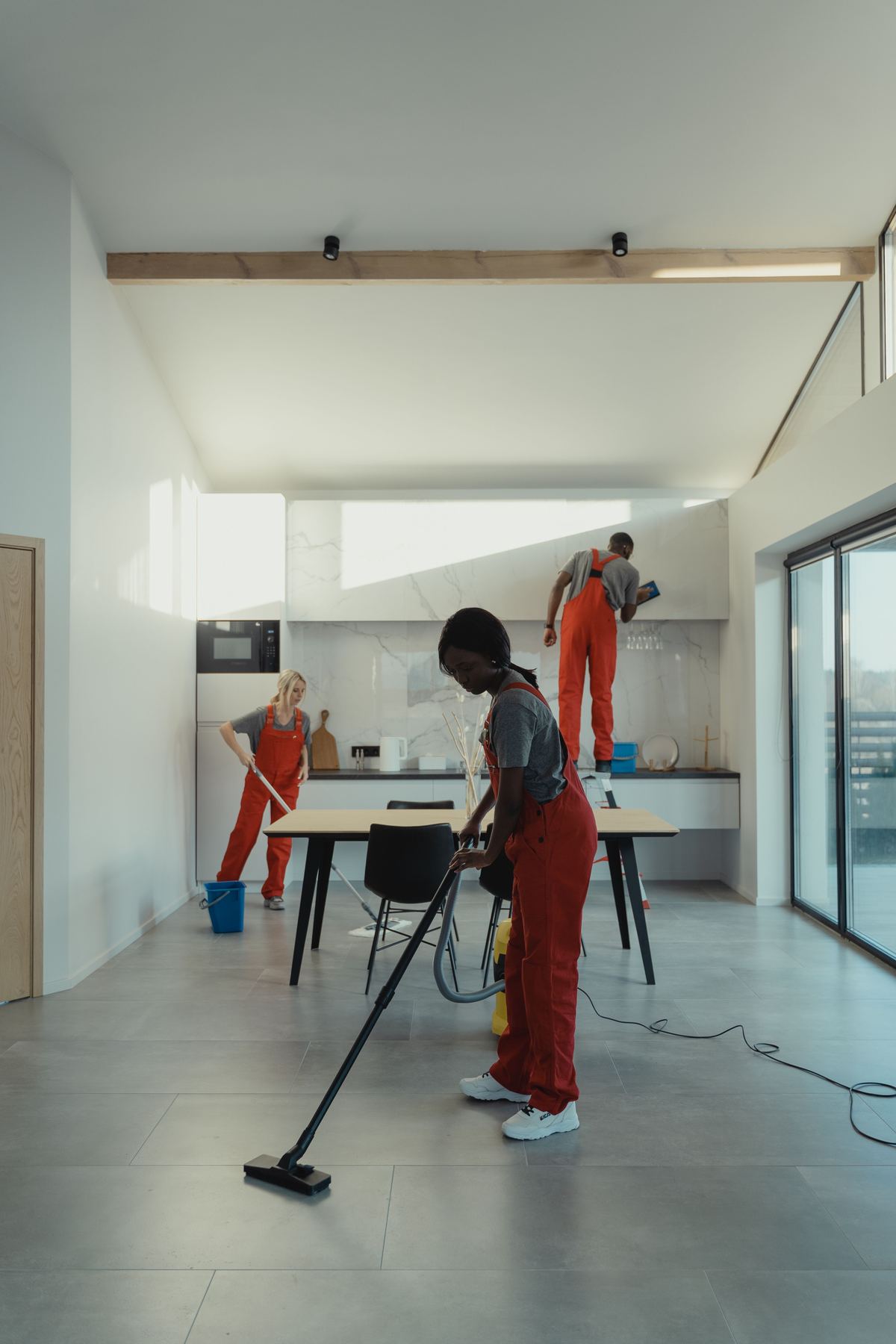 Team cleaning a newly finished open-plan kitchen